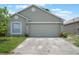 Home exterior with attached two car garage and concrete driveway at 8141 Golden Chickasaw Cir, Orlando, FL 32825