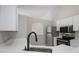Kitchen featuring white cabinets and modern stainless steel appliances and an arched doorway at 8141 Golden Chickasaw Cir, Orlando, FL 32825