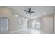 Open living room with tile floors, ceiling fan, and arched doorway at 8141 Golden Chickasaw Cir, Orlando, FL 32825