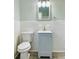 Well-maintained bathroom with modern vanity, toilet, and updated tile work at 820 Maley St, Daytona Beach, FL 32114