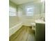 Updated bathroom with a modern vanity, toilet, bathtub, and stylish wood-look flooring for a fresh look at 820 Maley St, Daytona Beach, FL 32114