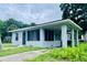 Charming home showcasing a screened porch with a covered carport on the side at 820 Maley St, Daytona Beach, FL 32114