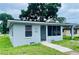 Cozy single-story home featuring a screened porch and simple, clean landscaping at 820 Maley St, Daytona Beach, FL 32114