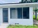Enclosed screened porch offering a view of the house's interior door and adjacent carport at 820 Maley St, Daytona Beach, FL 32114