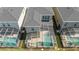 Aerial view of backyard pool with screened enclosure and patio, surrounded by green lawns at 8964 Takeaway Way, Davenport, FL 33896