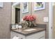 Bathroom featuring a vanity, neutral wallpaper, fresh flowers, and a sink with a modern faucet at 8964 Takeaway Way, Davenport, FL 33896