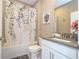 Bathroom showcasing a floral shower curtain, modern vanity, and stylish decor at 8964 Takeaway Way, Davenport, FL 33896