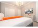 Bedroom featuring an elegant chandelier, large television, and white dresser for ample storage space at 8964 Takeaway Way, Davenport, FL 33896