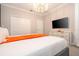 Bedroom featuring an elegant chandelier, large television, and white dresser for ample storage space at 8964 Takeaway Way, Davenport, FL 33896