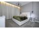 Modern bedroom with plush carpet, stylish pendant lights, a large headboard and unique decor at 8964 Takeaway Way, Davenport, FL 33896