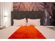 Bedroom features a decorative accent wall and soft white linens at 8964 Takeaway Way, Davenport, FL 33896