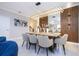 Modern dining room with stylish lighting, wood paneling, and seating for six at 8964 Takeaway Way, Davenport, FL 33896