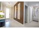Inviting entryway with elegant lighting, a stylish accent wall, and a glimpse into the bathroom at 8964 Takeaway Way, Davenport, FL 33896