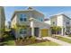 Close up of a modern house with stone accents, a yellow garage door, and fresh landscaping at 8964 Takeaway Way, Davenport, FL 33896