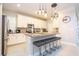 Kitchen offers a spacious island with seating and stainless-steel appliances at 8964 Takeaway Way, Davenport, FL 33896