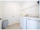 Practical laundry room equipped with modern washer, dryer, and ample shelving at 8964 Takeaway Way, Davenport, FL 33896