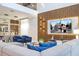 The open floor plan features a dining area and living room with modern decor and a two-story wood paneled accent wall at 8964 Takeaway Way, Davenport, FL 33896