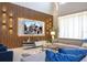 Beautifully decorated living room with wood accent wall, plush seating, and ample natural light at 8964 Takeaway Way, Davenport, FL 33896