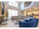 Bright and airy living room with soaring ceilings, large sectional sofa, and open floor plan at 8964 Takeaway Way, Davenport, FL 33896