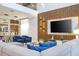 Cozy living area with wood accent wall, plush seating, and open floor plan at 8964 Takeaway Way, Davenport, FL 33896