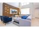 Bright living room features a vaulted ceiling, wood accent wall, and comfortable gray sectional at 8964 Takeaway Way, Davenport, FL 33896