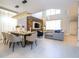 The open floor plan features a dining area and living room with modern decor and a soaring ceiling at 8964 Takeaway Way, Davenport, FL 33896