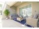 Charming covered patio with stylish outdoor furniture, perfect for relaxing and enjoying the pool views at 8964 Takeaway Way, Davenport, FL 33896