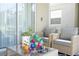 Relaxing patio with wicker furniture, glass-top table, and view of the sliding glass doors at 8964 Takeaway Way, Davenport, FL 33896