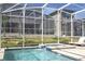 Beautiful pool and spa area with serene backyard views, enclosed in a screened-in patio for year-round enjoyment at 8964 Takeaway Way, Davenport, FL 33896