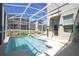 Gorgeous screened-in pool and spa with backyard views, plus convenient access to the home's interior at 8964 Takeaway Way, Davenport, FL 33896