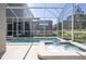Sparkling screened-in pool and spa offer a private oasis with views of the landscaped backyard and surrounding homes at 8964 Takeaway Way, Davenport, FL 33896