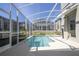 Inviting pool and spa within a screened enclosure overlooking the backyard at 8964 Takeaway Way, Davenport, FL 33896