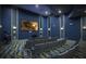 Comfortable home theater featuring tiered seating, projector, and surround sound at 8964 Takeaway Way, Davenport, FL 33896