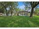A home with a large, lush green backyard featuring a screened in pool at 898 Shed St, Oviedo, FL 32765