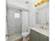 Well lit bathroom featuring marble tiling in the shower and modern vanity at 898 Shed St, Oviedo, FL 32765