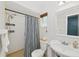 Bathroom with a shower with a decorative curtain and white tiled walls at 898 Shed St, Oviedo, FL 32765