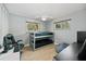 Cozy bedroom with fan, wood-look floors, natural light, bunk beds, and workstation at 898 Shed St, Oviedo, FL 32765