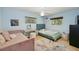 Well-lit bedroom with light blue walls, wood floors, and decor with a vanity at 898 Shed St, Oviedo, FL 32765