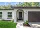 Inviting front entrance showcases decorative door with sidelights, arched transom window and meticulously maintained landscaping at 898 Shed St, Oviedo, FL 32765