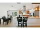 Open kitchen with bar seating flows into dining area with backyard views and a smooth transition to an office space at 898 Shed St, Oviedo, FL 32765