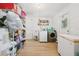 Organized laundry room with sink, shelving, washer, and dryer at 898 Shed St, Oviedo, FL 32765