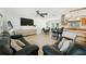 Open-concept living space features stylish decor, modern lighting, wood-look floors, and seamless flow to the kitchen at 898 Shed St, Oviedo, FL 32765