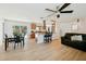 Bright and airy living area features updated flooring, modern lighting, and a smooth transition to the dining and kitchen areas at 898 Shed St, Oviedo, FL 32765