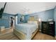 Main bedroom features wood floors, modern fan, closet, and teal painted walls at 898 Shed St, Oviedo, FL 32765
