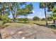 Wide view of backyard, including large tree and patio area, and neighboring properties at 1115 Lake Francis Dr, Apopka, FL 32712