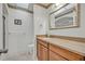 Bright bathroom with decorative accents, skylight, granite countertop, and tiled floors at 1115 Lake Francis Dr, Apopka, FL 32712