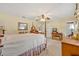 A cozy bedroom with a wooden four poster bed, carpeted floors, and a window for natural light at 1115 Lake Francis Dr, Apopka, FL 32712