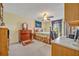 A cozy bedroom with a wooden bed, carpeted floors, and a window for natural light at 1115 Lake Francis Dr, Apopka, FL 32712