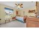 A cozy bedroom with a wooden bed, carpeted floors, and a window for natural light at 1115 Lake Francis Dr, Apopka, FL 32712