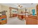 A cozy bedroom with a wooden four poster bed, carpeted floors, and a window for natural light at 1115 Lake Francis Dr, Apopka, FL 32712